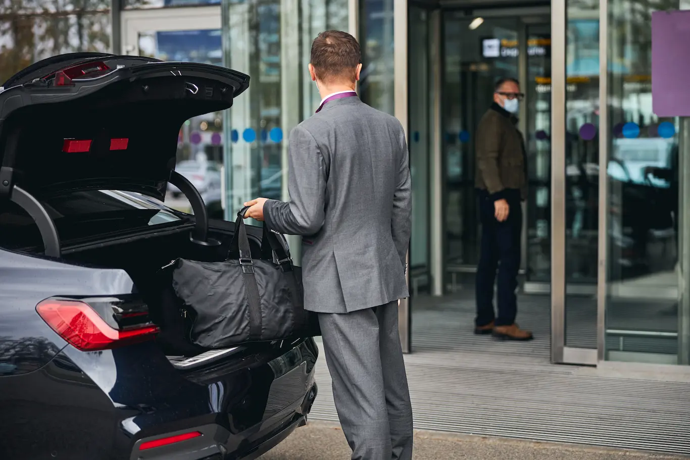 Chauffeur helping the passenger with their bags